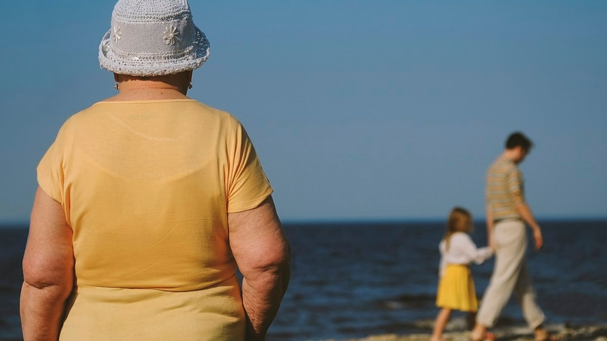 man in yellow crew neck t-shirt standing on beach during daytime