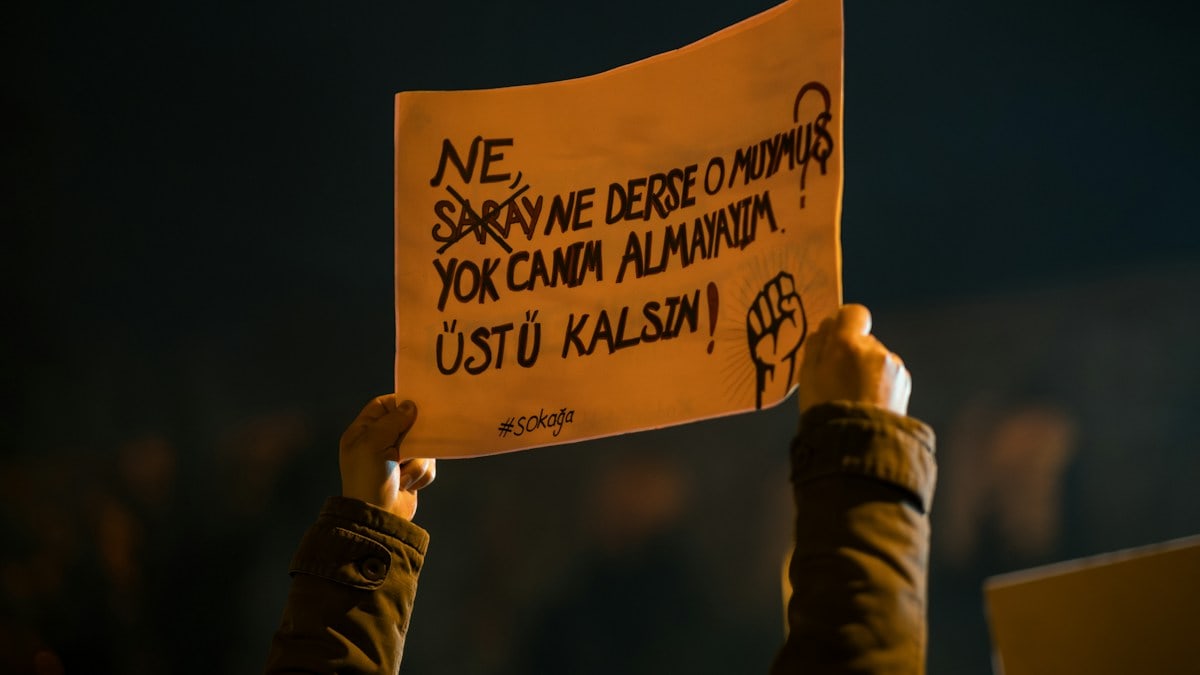 Protester holds sign with turkish text